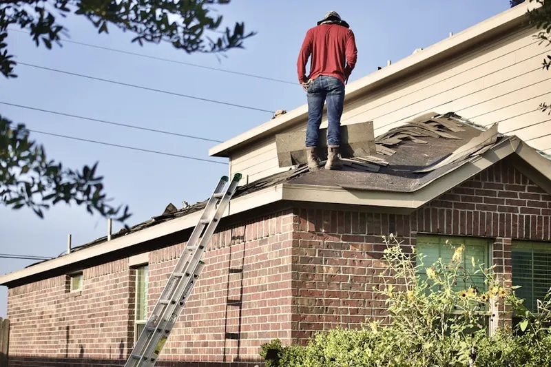 Professional roofer working on a residential roof in Sykesville